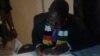 Justice Minister Ziyambi Ziyambi signing documents to acknowledge authenticity of presidential results.