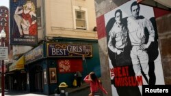 FILE - The figures of author Jack Kerouac (L) and Neal Cassady are painted on the wall of the Beat Museum in the North Beach neighborhood in San Francisco, California, May 27, 2012. 