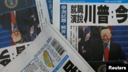 FILE - Copies of the Taiwanese daily newspaper Liberty Times, with its front page featuring the inauguration of Donald Trump as U.S. president, are seen at a printing house in Taipei, Taiwan, Jan. 21, 2017. For the past year, the U.S. has been boosting its ties with the island, despite recognizing it as part of China.