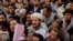 Afghans gather outside the passport office after Taliban officials announced they will start issuing passports to its citizens again, following delays that hampered attempts by those trying to flee the country after the Taliban seized control, in Kabul, A