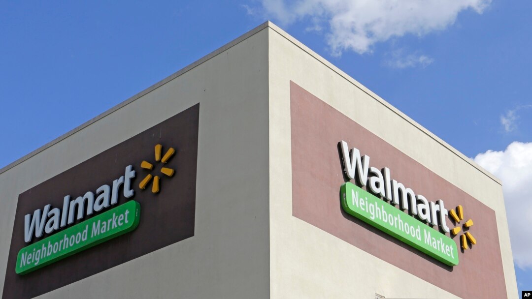 This Feb. 8, 2017, photo shows Wal-Mart signage at one of the company's neighborhood markets, in Hialeah, Florida.