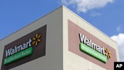 FILE - This Feb. 8, 2017, photo shows Wal-Mart signage at one of the company's neighborhood markets, in Hialeah, Florida.