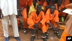 FILE - This undated photo shows prisoners sitting together at the central prison in Juba, South Sudan.