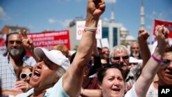 FILE - Supporters of Turkey's Republican People's Party protest outside a court in Istanbul, where CHP Istanbul provincial chairwoman Canan Kaftancioglu appeared, July 18, 2019. Kaftancioglu is standing trial for tweets she posted on social media.