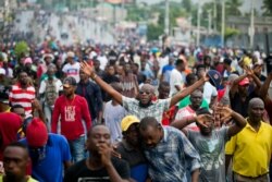 FILE - Demonstrators chant anti-government slogans during a protest in Port-au-Prince, Haiti, Sept. 20, 2019.