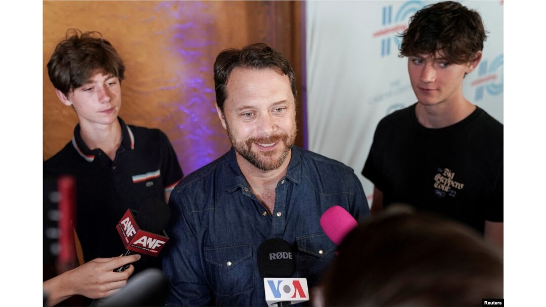 Jason Carter, grandson of Jimmy Carter, speaks to the media while accompanied by his sons on the red carpet for "Jimmy Carter 100: A Celebration in Song" at the Fox Theater, in Atlanta, Georgia, U.S. September 17, 2024. REUTERS/Elijah Nouvelage