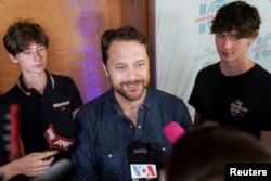 Jason Carter, grandson of Jimmy Carter, speaks to the media while accompanied by his sons on the red carpet for "Jimmy Carter 100: A Celebration in Song" at the Fox Theater, in Atlanta, Georgia, U.S. September 17, 2024. REUTERS/Elijah Nouvelage