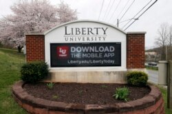 FILE - A sign marks the entrance to Liberty University in Lynchburg, Va., March 24 , 2020.