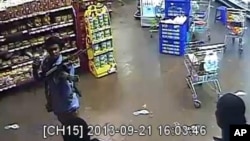 In this photo taken from footage from Citizen TV, via the Kenya Defense Forces and made available Friday, Oct. 4 2013, a man reported to be Omar Abdul Rahim Nabhan, one of the four armed militants walking in a store at the Westgate Mall.