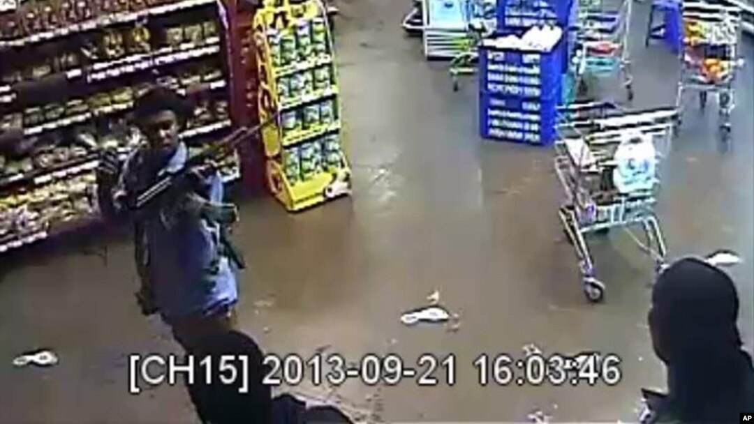 In this photo taken from footage from Citizen TV, via the Kenya Defense Forces and made available Friday, Oct. 4 2013, a man reported to be Omar Abdul Rahim Nabhan, one of the four armed militants walking in a store at the Westgate Mall.