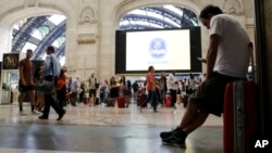 People wait in a railway station, in Milan, Italy, during a general transport strike, June 16, 2017. 