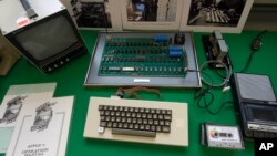 An Apple 1 Computer from 1976 made by Steve Jobs and Steve Wozniak is presented at an auction house in Cologne, Germany, Saturday, Nov. 16, 2013. (AP Photo/Martin Meissner)