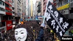 8일 홍콩 시내 행진 참가자가 '광복 홍콩'ㆍ'시대혁명'이라고 적힌 깃발을 흔들고 있다. 