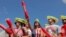 People cheer ahead of the Nathan's Famous Fourth of July Hot Dog-Eating Contest held on Independence Day at Maimonides Park in Brooklyn, New York City.