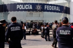 Striking police continue to hold a federal police command center in the Iztapalapa borough, in Mexico City, July 4, 2019, to protest against plans to force them into the newly formed National Guard.