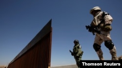 Members of Mexico's National Guard patrol along the border between Mexico and the U.S., in Anapra, on the outskirts of Ciudad Juarez, Mexico, June 28, 2019. 