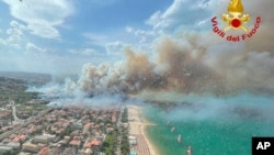 In this photo released by the Italian Firefighters, a view of a violent wildfire that burned the historical pinewood in Pescara, central Italy, Aug. 1, 2021.