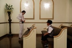 FILE - Eddie Powers prepares to perform a wedding at the Shalimar Wedding Chapel in Las Vegas, Aug. 1, 2017. Elvis impersonators remain a staple of Las Vegas kitsch, performing in wedding chapels and casino venues and on street corners.