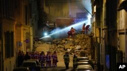 Firefighters work after building collapsed early April 9, 2023 in Marseille, southern France. 