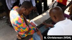 A government official tests an electronic questionnaire in Old Fadama, Accra’s largest slum, ahead of Ghana’s first digital population and housing census in 2020, May 24, 2019.