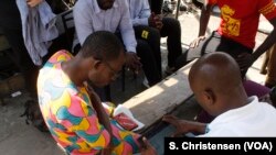 A government official tests an electronic questionnaire in Old Fadama, Accra’s largest slum, ahead of Ghana’s first digital population and housing census in 2020, May 24, 2019.