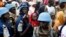 FILE- In this Nov. 30, 2015 file photo, UN soldiers stand near Muslims faithful queuing to enter the Central Mosque on the occasion of Pope Francis' visit, in Bangui's Muslim enclave of PK5, Central African Republic.