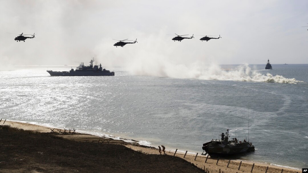 FILE - Russian navy ships and helicopters take a part in a landing operation during military drills at Crimea's Black Sea coast.