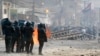 FILE: Cambodian riot police prepare to confront with garment workers throwing stones and bricks near a factory on the Stung Meanchey complex on the outskirts of Phnom Penh, Cambodia, Friday, Jan. 3, 2014. 