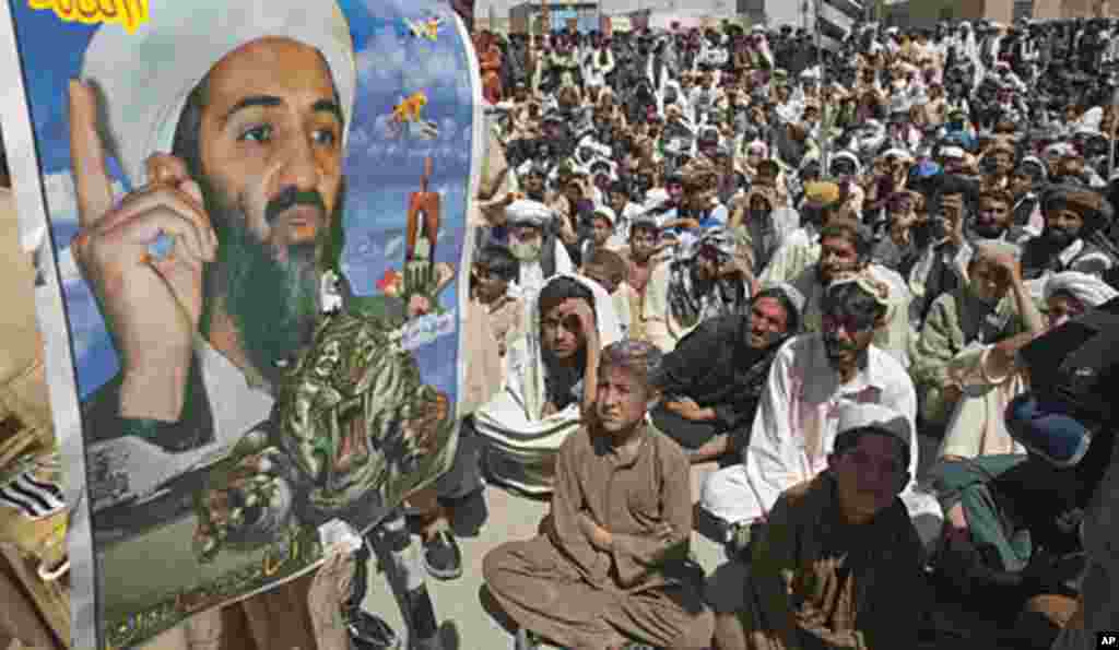 Supporters of Pakistani religious party Jamiat-e-ulema-e-Islam are seen near an image of al-Qaeda leader Osama bin Laden during an anti-U.S. rally on the outskirts of Quetta May 6, 2011 (Reuters).