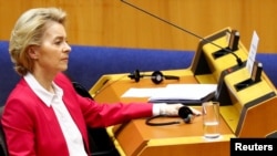 European Commission President Ursula von der Leyen wears protective gloves during a special session of the European Parliament to approve special measures to soften the sudden economic impact of COVID-19, in Brussels, Belgium, March 26, 2020.