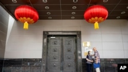 FILE - Visitors try to enter the Chinese Consulate General in Houston, July 22, 2020.