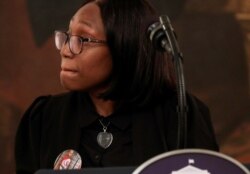 Charron Powell, whose son LeGend Taliferro was shot and killed in Kansas City in June, wears a button honoring her late son as she speaks during an event where U.S. President Donald Trump spoke about "Operation Legend," named for the boy.