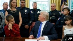President Donald Trump speaks in the Oval Office of the White House in Washington, May 15, 2017, where he signed a law enforcement proclamation. 