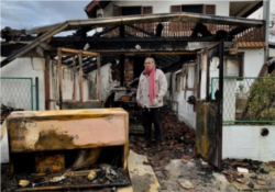 Milan Jovanovic in front of his burned home, in Belgrade, Serbia, December 2018.