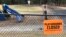 FILE - This March 20, 2020 file photo shows a closed sign near an entrance to a playground at an elementary school in Walpole, Mass., amid the COVID-19 outbreak.