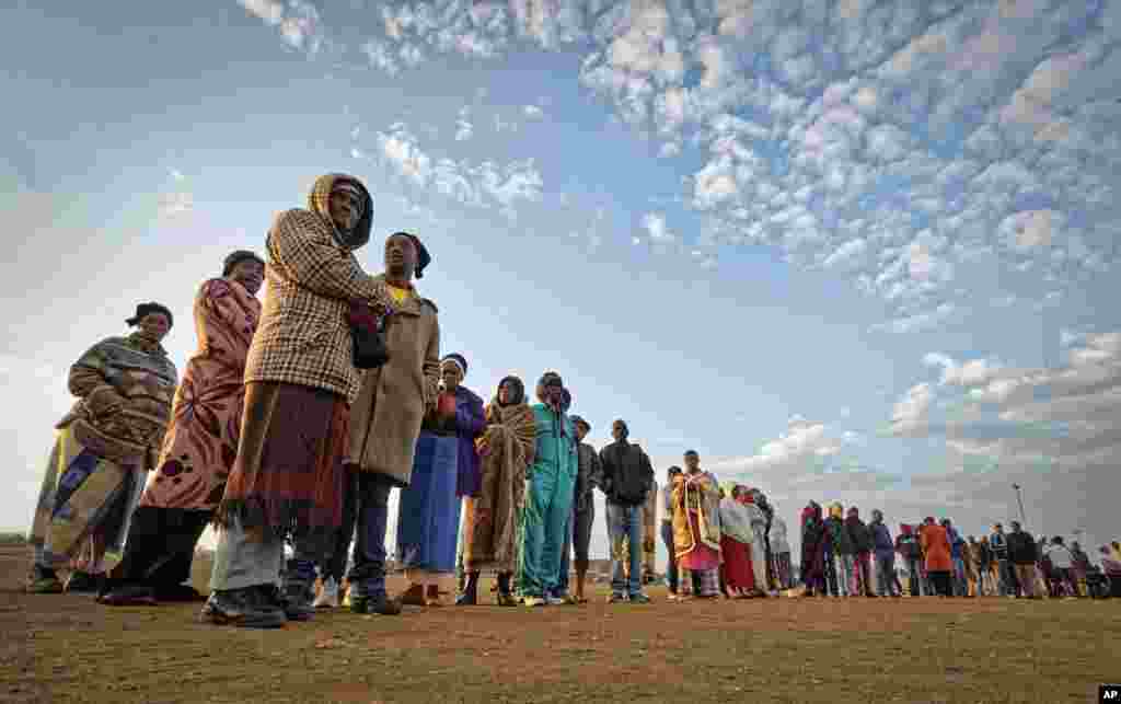 Warga Afrika Selatan mengantri di awal pagi yang dingin untuk memberikan suara merka pada pemilihan legislatif yang ke-6 di negara itu sejak awal demokrasi, di sebuah pemukiman pekerja tambang di Bekkersdal, sebelah barat Johannesburg.