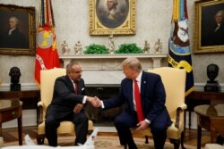 President Donald Trump shakes hands with Bahrain's Crown Prince Salman bin Hamad Al Khalifa​ during a meeting in the Oval Office of the White House, Sept. 16, 2019, in Washington.