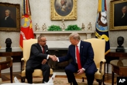 President Donald Trump shakes hands with Bahrain's Crown Prince Salman bin Hamad Al Khalifa​ during a meeting in the Oval Office of the White House, Sept. 16, 2019, in Washington.