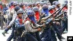 Burmese military address a protest in this file photo from 2007. The government continues to crack down on dissent, according to the U.S. Department of State.