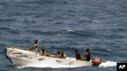 In this U.S. Navy photo, pirates leave the Ukrainian merchant vessel MV Faina for Somalia's shore Wednesday, Oct. 8, 2008 while under observation by a U.S. Navy ship. The MV Faina, which was carrying a cargo of Ukrainian T-72 tanks and related military eq