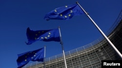 FILE PHOTO: European Union flags flutter outside the European Commission headquarters in Brussels