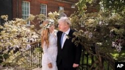 Downing Street handout photo of Prime Minister Boris Johnson and Carrie Johnson in the garden of 10 Downing Street after their wedding on Saturday. (Rebecca Fulton/Downing Street via AP)