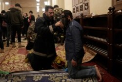 An anti-government protester receives treatment after confrontation with Lebanese riot police inside the Mohammad al-Amin Mosque during a protest in Beirut, Lebanon, Jan. 18, 2020.