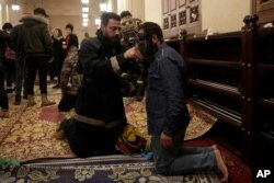 An anti-government protester receives treatment after confrontation with Lebanese riot police inside the Mohammad al-Amin Mosque during a protest in Beirut, Lebanon, Jan. 18, 2020.