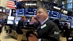 Trader George Ettinger works on the floor of the New York Stock Exchange, Nov. 13, 2015. 