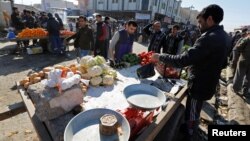 People do shopping after returning to their homes in the Al-Zuhoor neighborhood of Mosul, Iraq, Jan. 12, 2017. 