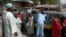 Residents survey vehicles damaged after a bomb blast at a primary school in Maiduguri, the capital of Nigeria's Borno state, February 29, 2012. 