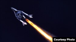 FILE - Virgin Galactic's SpaceShip2 under rocket power, its first ever since the program began in 2005. (Virgin Galactic)