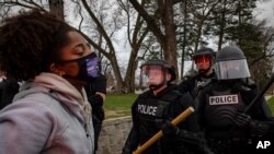 Protesters clash with police after a man was shot and killed by local law enforcement on April 11, 2021, in Brooklyn Center, Minn.