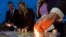 FILE - Members of Survivors Network of those Abused by Priests (SNAP) light candles during a protest to denounce abuses in Rome, April 25, 2014.